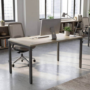 180cm desk with urban oak top and black frame in a modern office