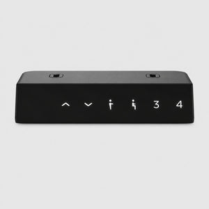 Close-up of black motorized desk legs memory handset