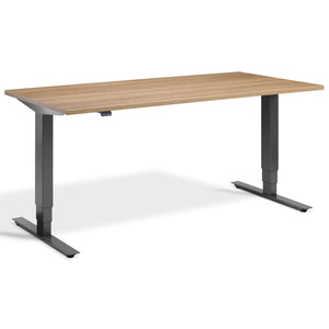Height Adjustable Computer Desk - Masta Desk - Dark Grey Frame - Brown Oak Top - Studio Image