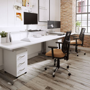 Leap electric standing desk converter on a white office desk in a modern workspace