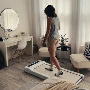 Lifespan Under Desk Walking Pad - The woman is using the treadmill inside her room