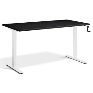 Manual crank standing desk with a black desk top, white frame and side-mounted crank handle