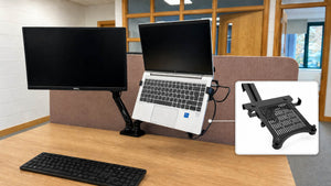 Monitor arm laptop holder supporting a laptop beside a screen
