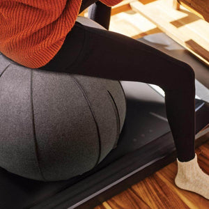 Over Treadmill Chair - Yoga Ball - A woman sitting on a Yoga Ball placed on top of the treadmill