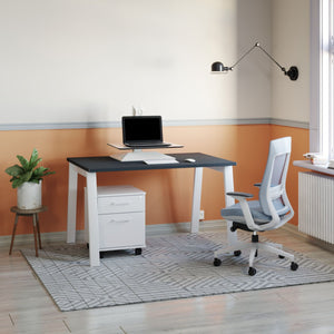 Standing desk converter electric setup on a compact desk with a laptop riser in a bright home office