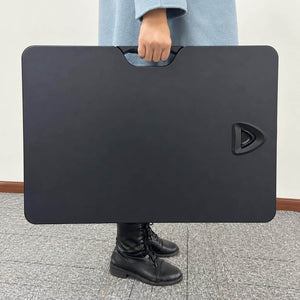 Yo Yo Lite portable desk converter being carried by its integrated handle for easy movement between workspaces