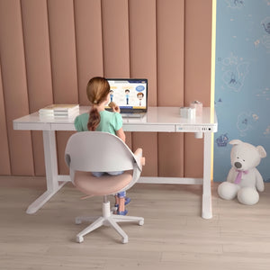 Girl sitting at Dextro white glass standing desk