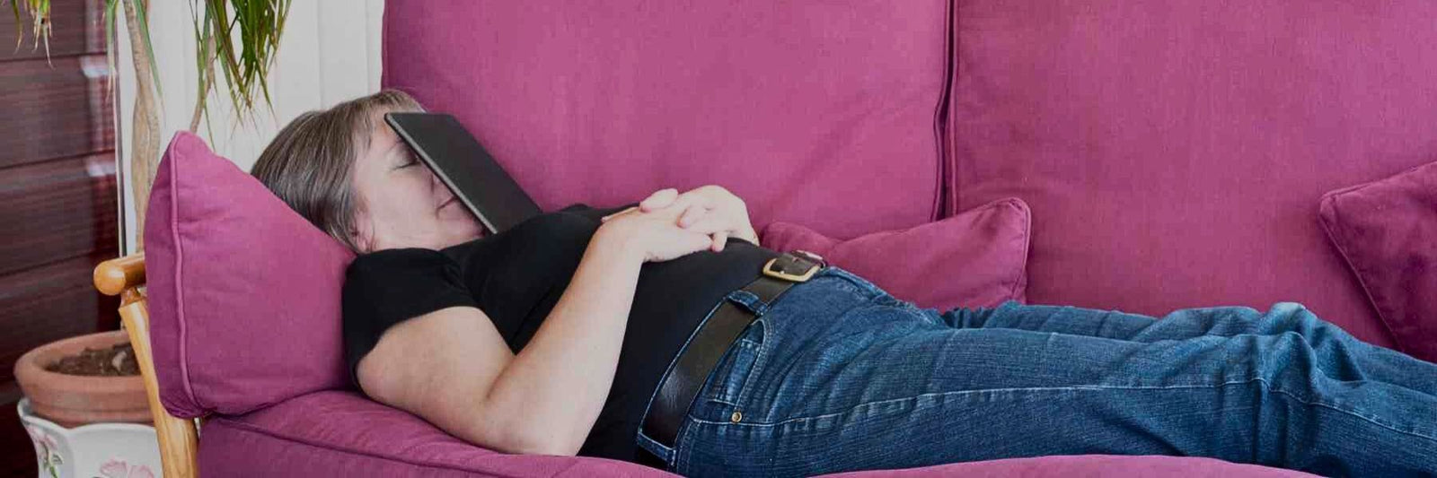 woman asleep on couch who needs to know how to stop living a sedentary lifestyle