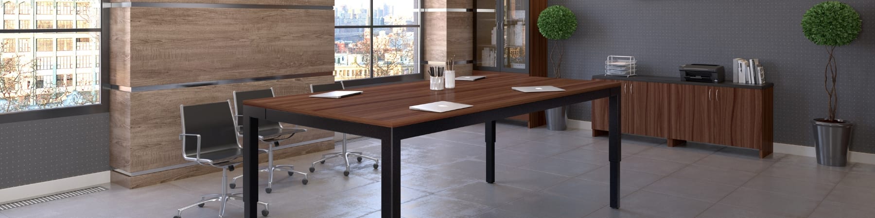 sit stand conference table in use in a meeting room viewed from one end