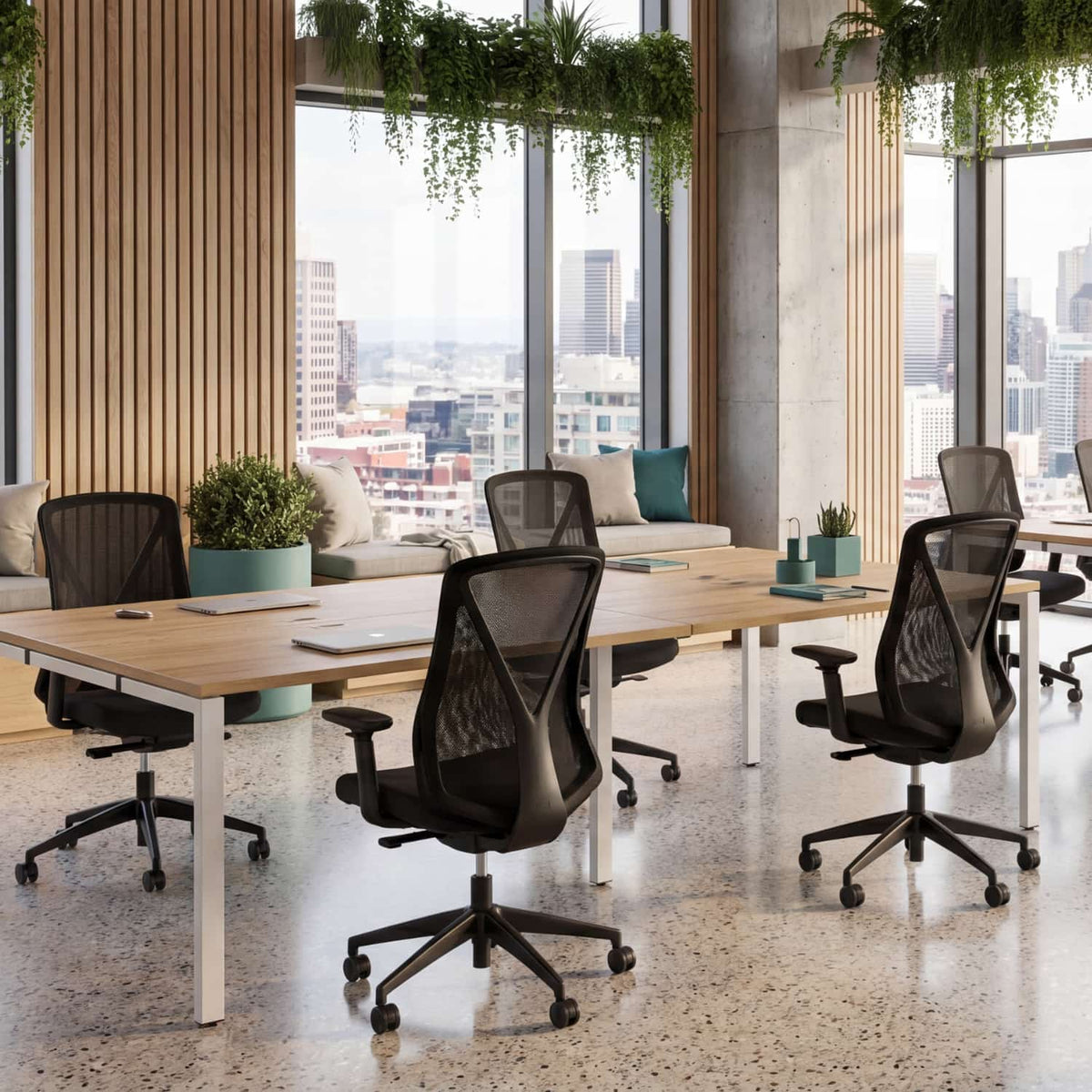 2 person dual bench desk in a contemporary office space with oak tops, white frames, and ergonomic task chairs