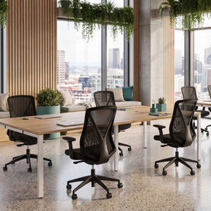 2 person dual bench desk in a contemporary office space with oak tops, white frames, and ergonomic task chairs