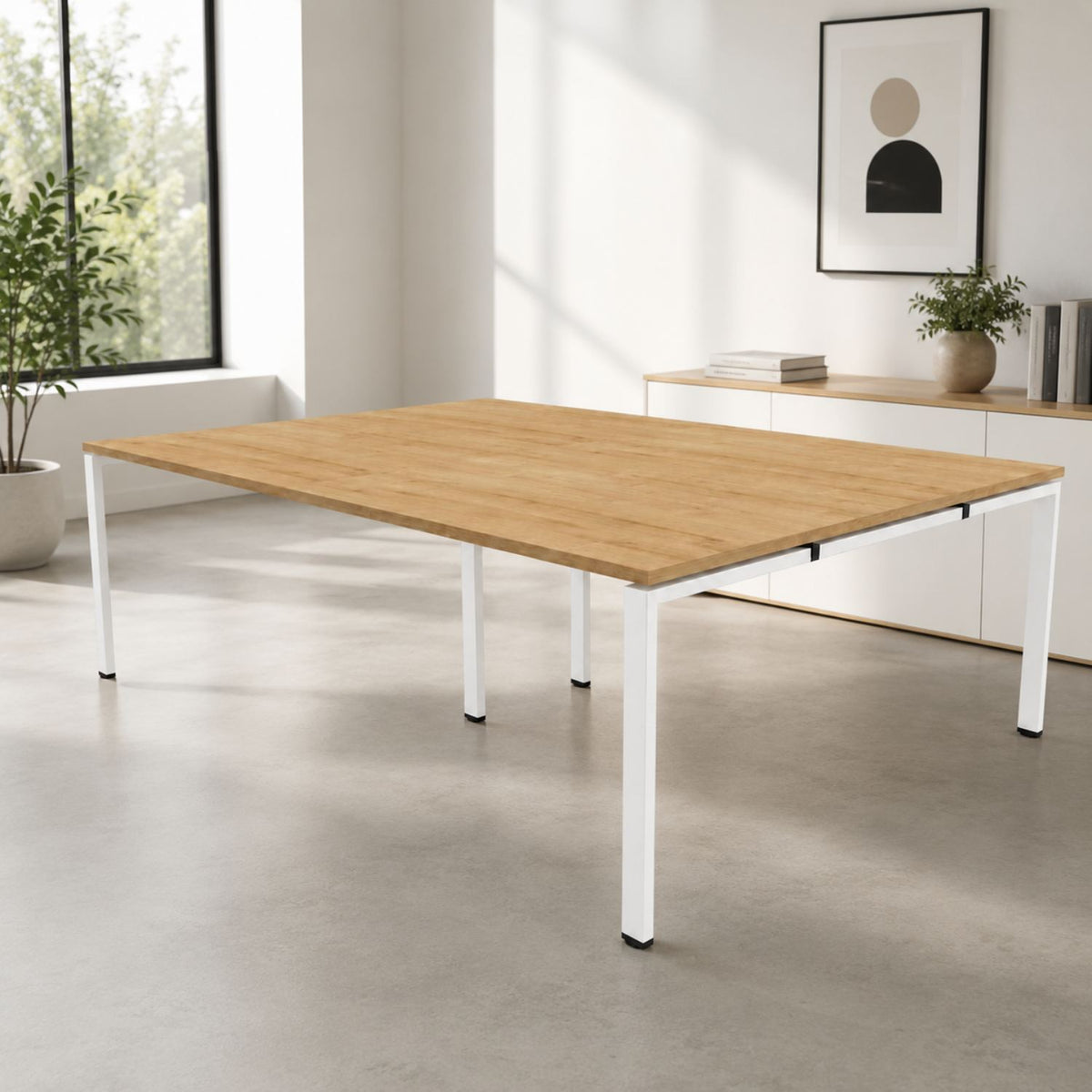 Bank of desks for 4 people with oak desktop and white frame shown in a modern office environment