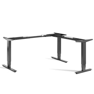 Masta adjustable corner standing desk frame in dark grey shown from the front