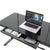 Dextro black glass standing desk with open drawer from front