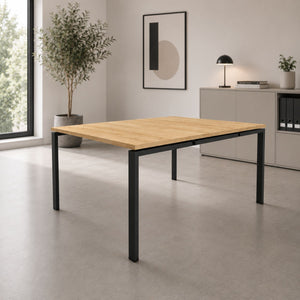 Dual desk for 2 people with oak top and black frame in a clean, modern office interior
