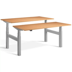 Duo adjustable desk with silver frame and Beech desk tops