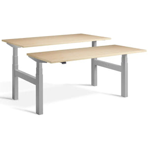 Duo adjustable desk with silver frame and Maple desk tops