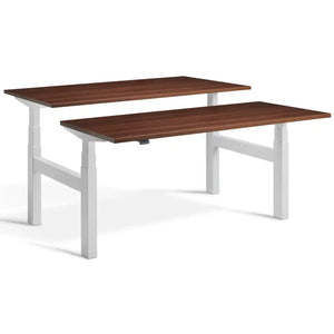 Duo height adjustable workstation with light grey frame and Natural Dijon Walnut desk tops