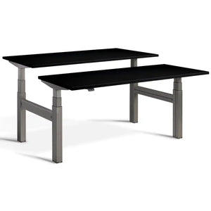 Duo height adjustable workstation with raw steel frame and Black desk tops