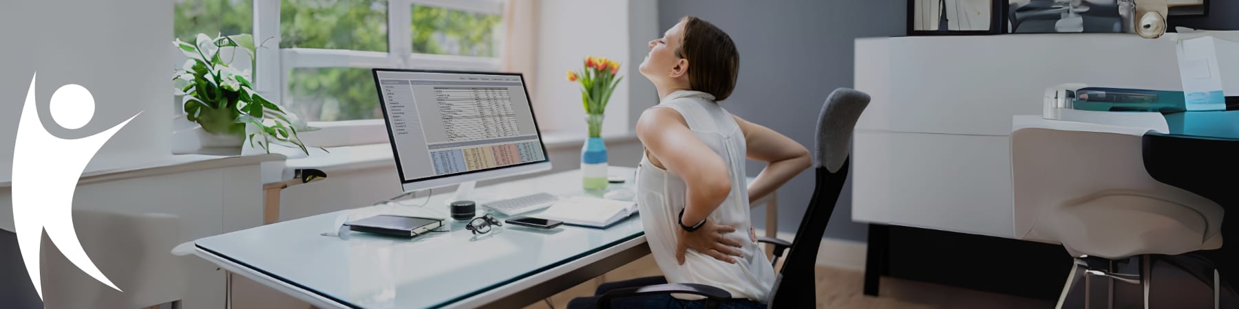 Woman at desk suffering back pain from sedentary working viewed from the side