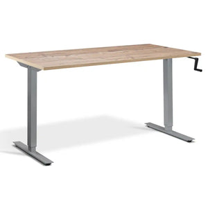 Hand crank standing desk with a timber desk top, silver frame and manual adjustment handle