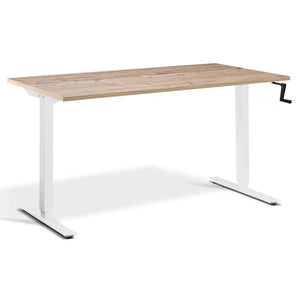 Hand crank standing desk with a timber desk top, white frame and manual adjustment handle