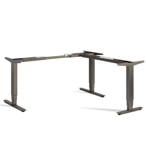 Lavoro Advance corner standing desk frame in raw steel finish viewed from the front