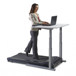 Woman using a Lifespan TR1200-DT7 Power walking treadmill desk whilst working