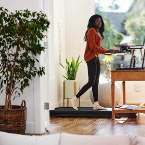 Tr1200 glowup walking treadmill in use in an office side view