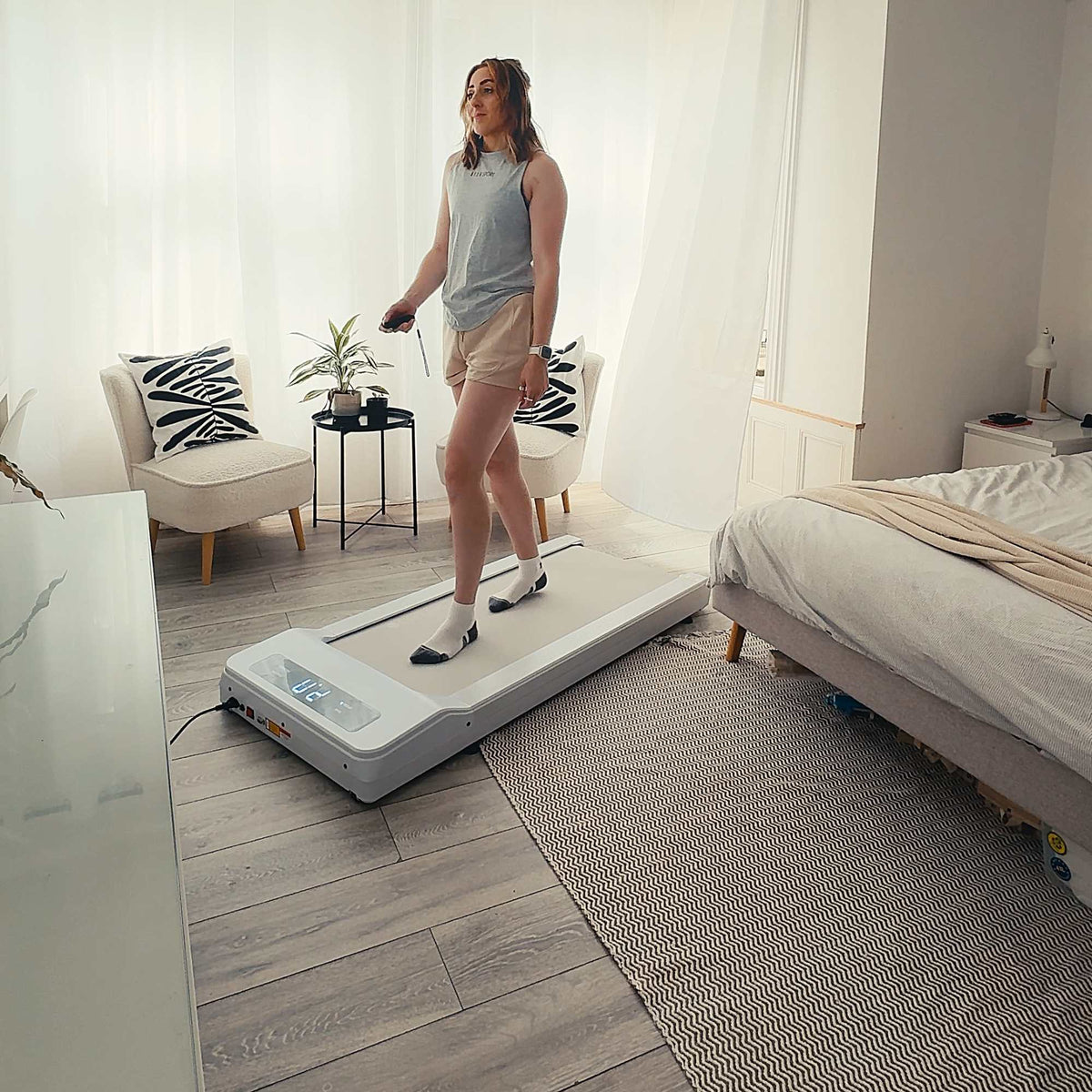 Lifespan Under Desk Walking Pad - A woman is working out with the treadmill inside her room