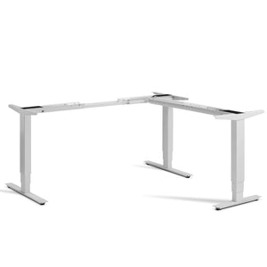 Masta corner adjustable desk frame in light grey shown from the front