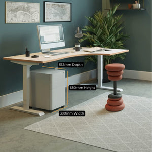 Moda Plus under desk pedestal positioned beneath a standing desk with dimensions shown