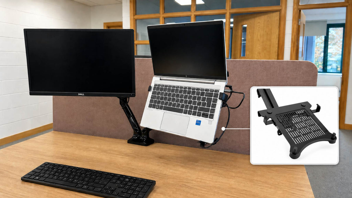 Monitor arm laptop holder supporting a laptop beside a screen