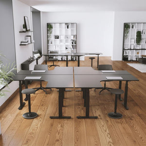 block of 4 height adjustable electric desks in an office setting
