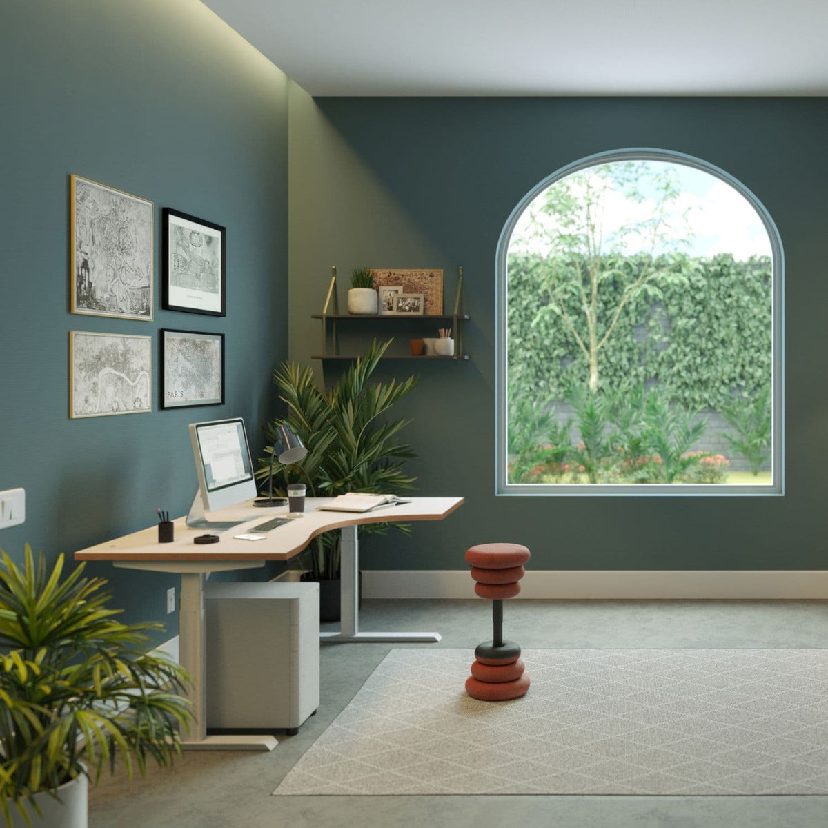 Standing desk with curve, light wood desk top and silver frame positioned beside a large arched window