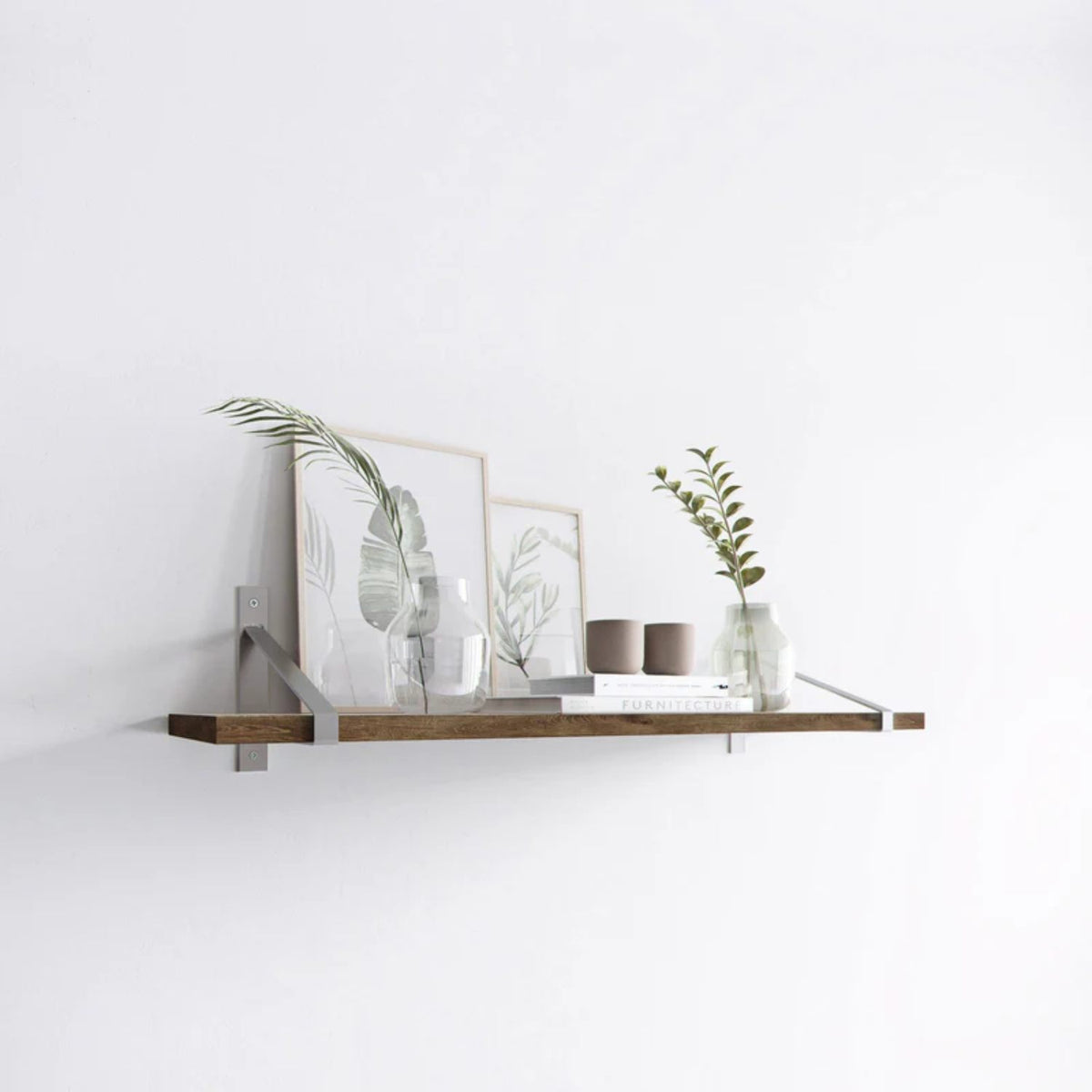 Suspense shelf brackets, clear coat, shelf styled with framed art