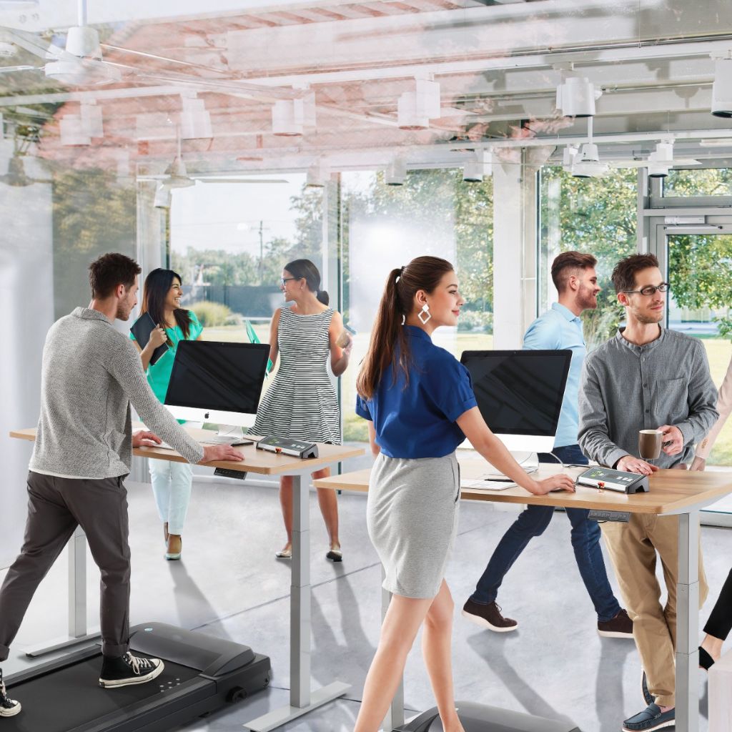 People actively working in the office - using standing desks and walking treadmills