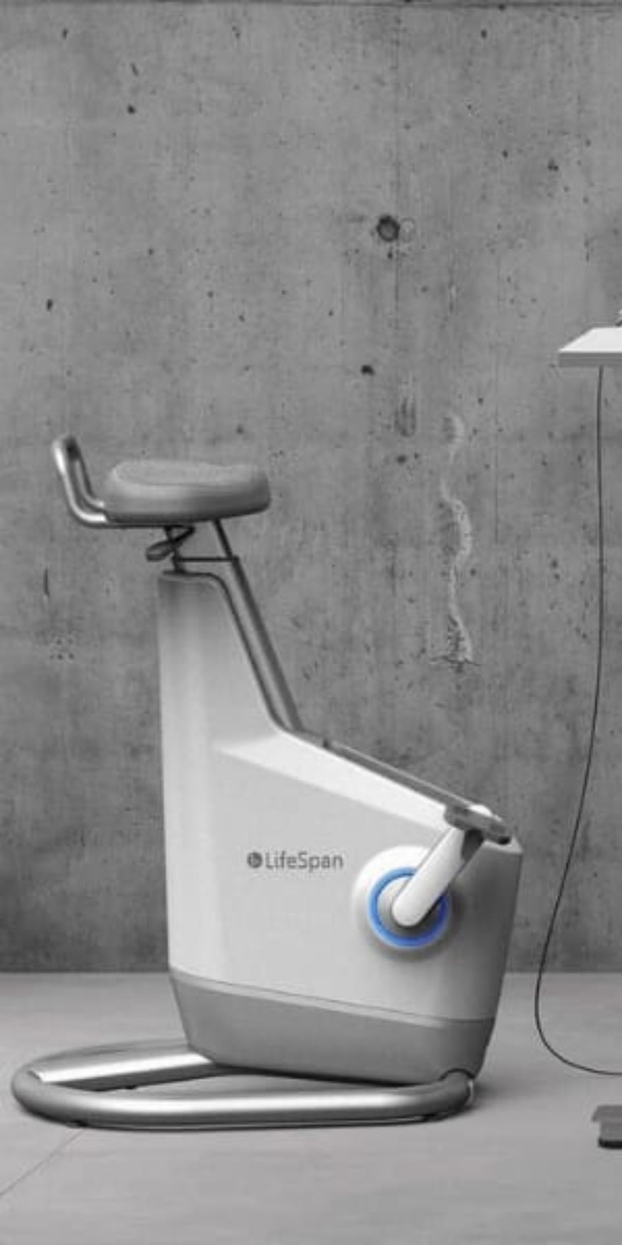 Lifespan Ampera under desk bike at a standing desk taken from side