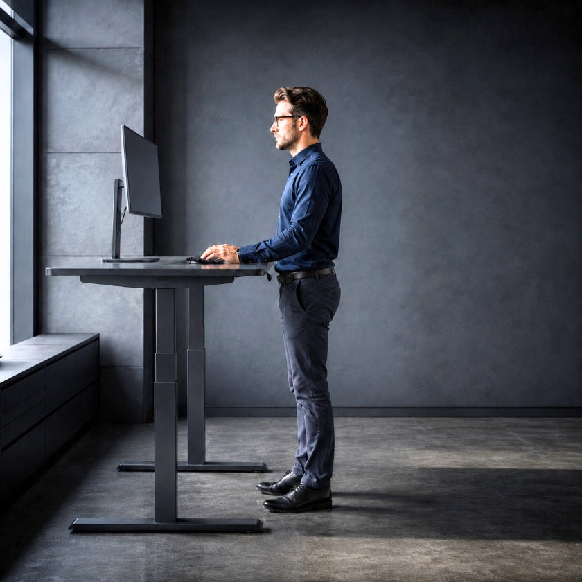 man using a standing desk adjusted to the correct height