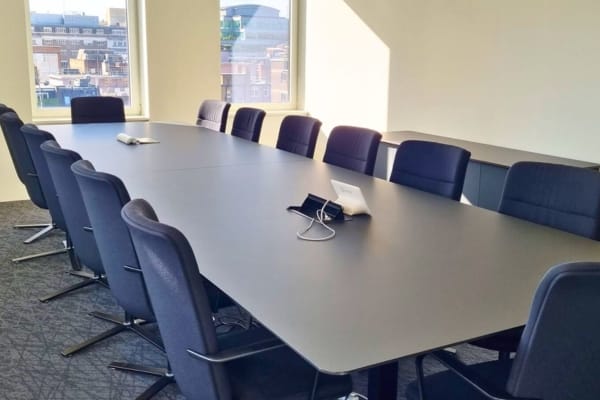 Large 2 piece meeting table top with dog bone joint viewed from one end