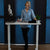 Woman standing at sit stand desk