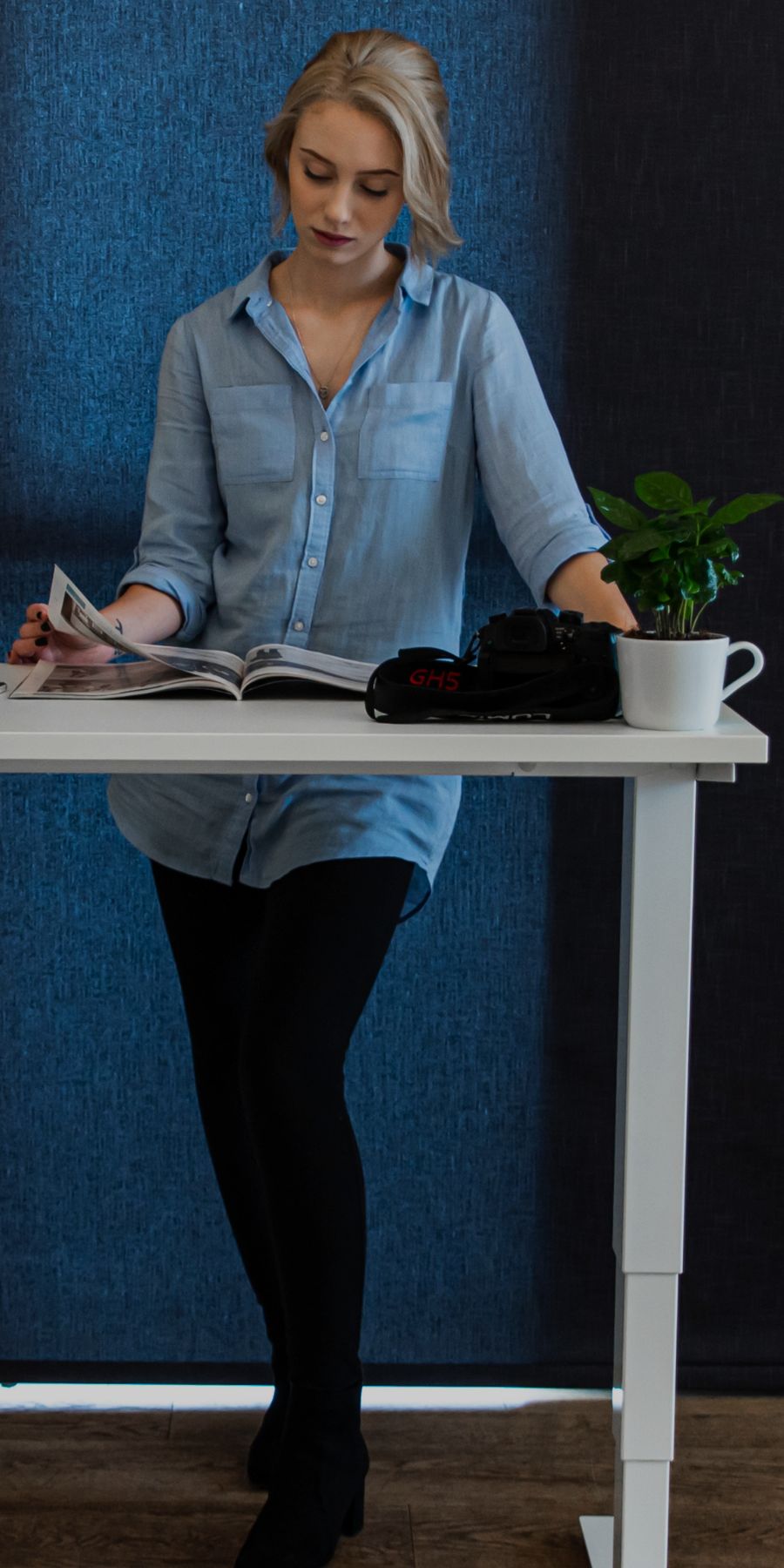 Woman standing at sit stand desk