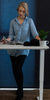 Woman standing at sit stand desk