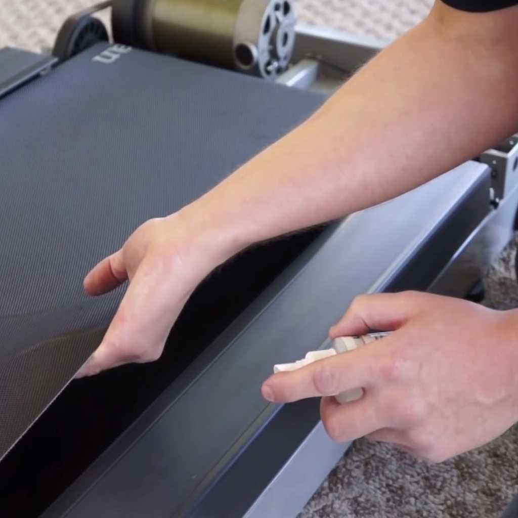 applying treadmill lubricant to belt