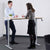 People standing at Helix manual sit stand desk