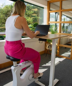 using desk bike at small corner standing desk right side view