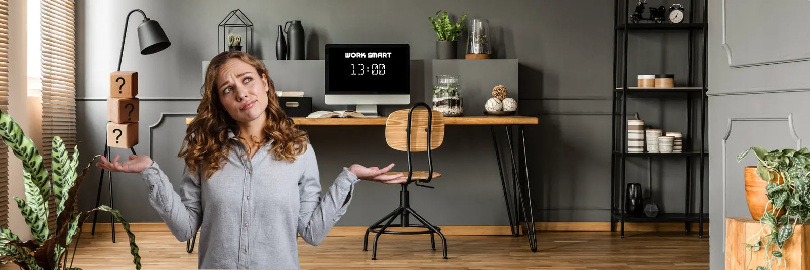Woman standing in a modern home office with a desk and computer setup, thinking about her desk choice - viewed from front